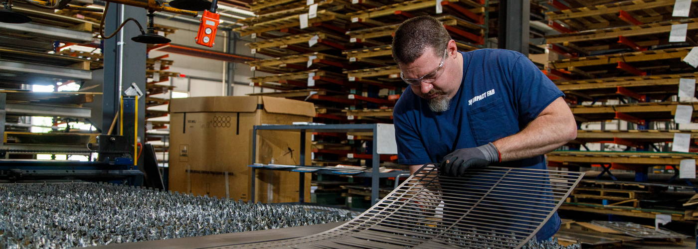 A man works on a laser cut product